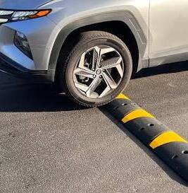 car tire driving over a speed bump