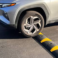 car tire driving over a speed bump